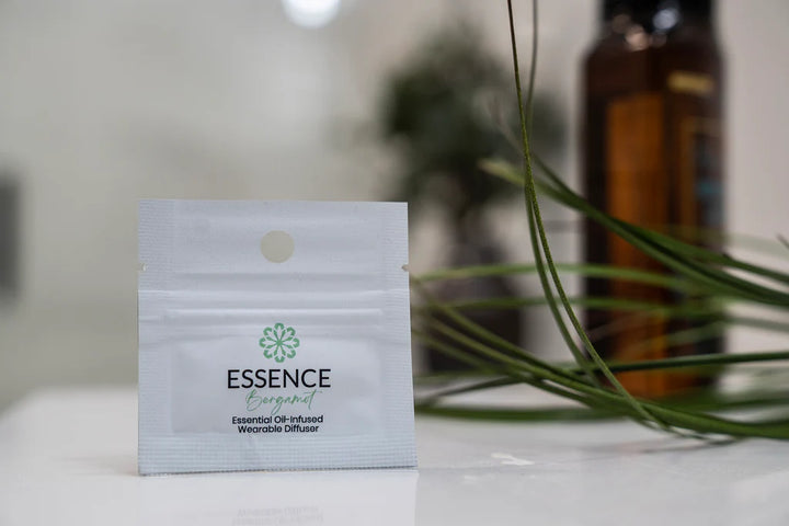 Essence essential oil diffuser package on a surface with a blurred background