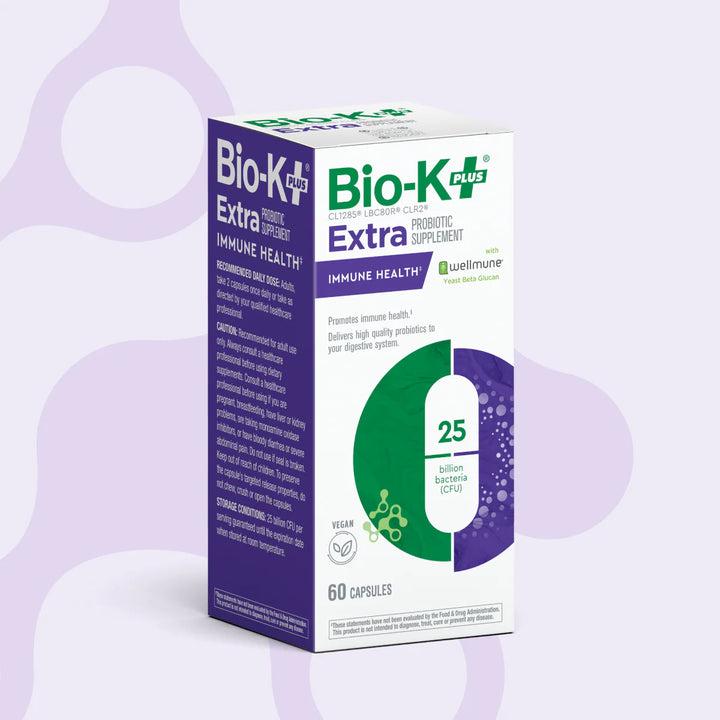 Bio-K Plus Extra probiotic supplement box on a light purple background